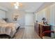 Bedroom with gray floors, a dresser, closet with folding doors and a bed with gray and gold bedding at 120 Buckeye Nw Ave, Port Charlotte, FL 33952