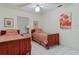 Bedroom with twin beds, wood frames, striped bedding, window with blinds and white tile floors at 120 Buckeye Nw Ave, Port Charlotte, FL 33952