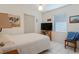 Bedroom with a white bed, window with blinds, white tile floors and TV on a wood stand at 120 Buckeye Nw Ave, Port Charlotte, FL 33952