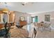 Bright dining space with tile floors, a decorative mirror, and convenient access to the kitchen at 120 Buckeye Nw Ave, Port Charlotte, FL 33952