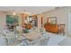 Open dining area featuring white tile flooring, stylish furniture, and access to the kitchen at 120 Buckeye Nw Ave, Port Charlotte, FL 33952