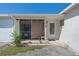 Inviting front entrance featuring a screened-in porch, creating a cozy and welcoming space at 120 Buckeye Nw Ave, Port Charlotte, FL 33952