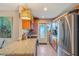 Bright kitchen with granite countertops, wood cabinets, stainless steel appliances and doorway to the exterior at 120 Buckeye Nw Ave, Port Charlotte, FL 33952