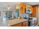 Modern kitchen features granite countertops, stainless steel appliances, and convenient access to the dining area at 120 Buckeye Nw Ave, Port Charlotte, FL 33952
