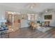 Living room with gray floors, ceiling fans, lots of windows, comfortable seating and view of a dining area at 120 Buckeye Nw Ave, Port Charlotte, FL 33952