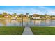 Scenic waterfront view featuring lush green grass, clear water, boat docks, and beautiful homes at 1251 Partridge Dr, Punta Gorda, FL 33950