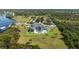Luxury estate featuring a pool, expansive lawn, tennis court and waterfront access at 13000 Windcrest Dr, Port Charlotte, FL 33953