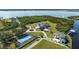 Expansive estate features lush grounds, tennis court, private dock, and circular driveway, all bordered by a scenic waterway at 13000 Windcrest Dr, Port Charlotte, FL 33953