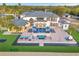 Expansive aerial view of a luxurious estate with a large pool, manicured grounds, and a putting green at 13000 Windcrest Dr, Port Charlotte, FL 33953