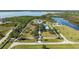 Expansive estate featuring lush grounds, a tennis court, and luxurious homes with waterfront access at 13000 Windcrest Dr, Port Charlotte, FL 33953