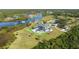 Waterfront estate featuring lush lawns, mature trees, a pool, and a private dock, perfect for luxurious outdoor living at 13000 Windcrest Dr, Port Charlotte, FL 33953