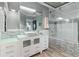 This bathroom has a double vanity, vessel sinks, a large mirror, and a glass-enclosed shower at 13000 Windcrest Dr, Port Charlotte, FL 33953