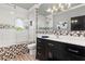 Bathroom featuring tub and shower combination, modern vanity, mirror and decorative lighting at 13000 Windcrest Dr, Port Charlotte, FL 33953