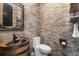 Bathroom with brick accent wall, barrel sink and metal frame mirror at 13000 Windcrest Dr, Port Charlotte, FL 33953
