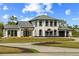 Stately two-story house showcases a well-manicured lawn and circular driveway at 13000 Windcrest Dr, Port Charlotte, FL 33953