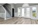 Bright foyer with tile floors, staircase, and double doors leading to the outside at 13000 Windcrest Dr, Port Charlotte, FL 33953