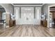 Grand foyer featuring elegant tile flooring, a decorative entry door, and stylish console tables at 13000 Windcrest Dr, Port Charlotte, FL 33953