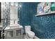 Stylish half bath featuring a vessel sink, mosaic wall, and elegant decor at 13000 Windcrest Dr, Port Charlotte, FL 33953