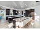 Spacious kitchen features a large island with counter seating, dark cabinetry, modern appliances, and backyard views at 13000 Windcrest Dr, Port Charlotte, FL 33953