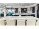 Spacious kitchen features a large island with counter seating, dark cabinetry, modern appliances, and backyard views at 13000 Windcrest Dr, Port Charlotte, FL 33953