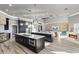 Spacious kitchen features a large island with counter seating, dark cabinetry, modern appliances, and backyard views at 13000 Windcrest Dr, Port Charlotte, FL 33953