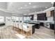 Spacious kitchen features a large island with counter seating, dark cabinetry, modern appliances, and backyard views at 13000 Windcrest Dr, Port Charlotte, FL 33953