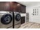 Well-equipped laundry room with modern washer, dryer, sink, and storage cabinets at 13000 Windcrest Dr, Port Charlotte, FL 33953