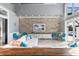 Bright living room boasts a stone accent wall, large windows with a view of the pool, and comfortable seating at 13000 Windcrest Dr, Port Charlotte, FL 33953