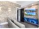 Stylish living room with stone accent wall, large screen TV and comfortable seating at 13000 Windcrest Dr, Port Charlotte, FL 33953