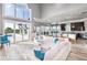 Bright living room with modern decor, large windows, and an open connection to the kitchen at 13000 Windcrest Dr, Port Charlotte, FL 33953
