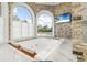 Serene soaking tub with a view, set in a luxurious bathroom with modern finishes and stone accents at 13000 Windcrest Dr, Port Charlotte, FL 33953