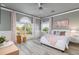 Light-filled main bedroom with wood-look floors, a large window with views of the property at 13000 Windcrest Dr, Port Charlotte, FL 33953