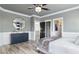 This bedroom offers a spacious layout with a large dresser, modern ceiling fan, and en suite bathroom at 13000 Windcrest Dr, Port Charlotte, FL 33953