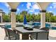 Covered outdoor dining area overlooking a luxurious pool at 13000 Windcrest Dr, Port Charlotte, FL 33953