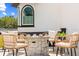 Cozy outdoor seating area with a brick fire pit, perfect for relaxing and entertaining at 13000 Windcrest Dr, Port Charlotte, FL 33953