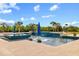 Beautiful pool featuring lounge chairs, sun umbrellas, and lush landscaping at 13000 Windcrest Dr, Port Charlotte, FL 33953