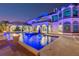 Luxurious pool with built-in lighting, fire bowls, and lounge seating, ideal for outdoor entertaining at 13000 Windcrest Dr, Port Charlotte, FL 33953