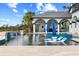 Resort style pool featuring a covered patio and a lush tropical backdrop at 13000 Windcrest Dr, Port Charlotte, FL 33953