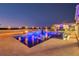 Inviting outdoor pool area with a cozy fire pit and tiki torches, perfect for evening relaxation at 13000 Windcrest Dr, Port Charlotte, FL 33953