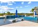 Stunning pool featuring lounge chairs, sun umbrellas, and water feature at 13000 Windcrest Dr, Port Charlotte, FL 33953