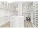 Spacious walk-in closet featuring custom shelving, an island, and ample storage space at 13000 Windcrest Dr, Port Charlotte, FL 33953