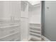 Walk-in closet features custom built-in shelves, drawers, and ample hanging space at 13000 Windcrest Dr, Port Charlotte, FL 33953