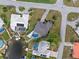 Aerial view of a beautiful home with a pool and nicely landscaped yard at 1301 Appian Dr, Punta Gorda, FL 33950