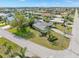 Beautiful aerial view of a home with an expansive lawn and lush tropical landscaping at 1301 Appian Dr, Punta Gorda, FL 33950