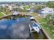Aerial view showcasing a home with a private boat lift and waterfront access at 1301 Appian Dr, Punta Gorda, FL 33950