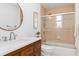 Bathroom featuring a shower over bath with a glass screen and wood vanity with white countertop at 1301 Appian Dr, Punta Gorda, FL 33950