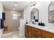 This bathroom offers a double sink vanity and a tiled shower with modern finishes at 1301 Appian Dr, Punta Gorda, FL 33950