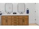 Modern bathroom features double sinks with marble countertops and wood cabinets at 1301 Appian Dr, Punta Gorda, FL 33950