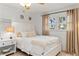 Bedroom featuring a bed, side table, and window with neutral colored curtains at 1301 Appian Dr, Punta Gorda, FL 33950