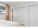 Bright bedroom featuring tan curtains and white closet doors at 1301 Appian Dr, Punta Gorda, FL 33950